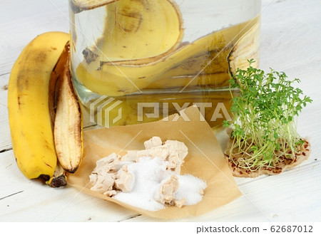 Banana peel, yeast and sugar in glass of water Banana peel, yeast and sugar in glass of water 62687012