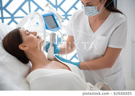 Woman on anti-age procedure of decollete zone Woman on anti-age procedure of decollete zone 62688885