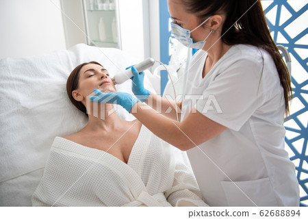 Young lady on anti-age procedure of face Young lady on anti-age procedure of face 62688894