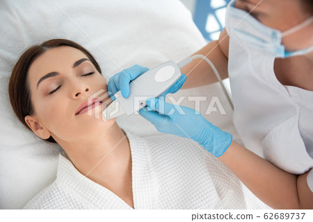 Top view lady on suprasonic procedure of face Top view lady on suprasonic procedure of face 62689737
