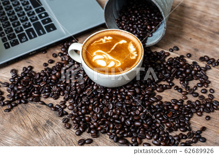 Latte art coffee cup and coffee bean with laptop 62689926