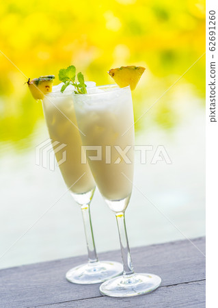 Ice cocktails glass on wooden floor around outdoor swimming pool Ice cocktails glass on wooden floor around outdoor swimming pool 62691260
