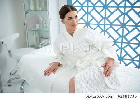 Happy relaxed lady reclining on massage couch Happy relaxed lady reclining on massage couch 62691739