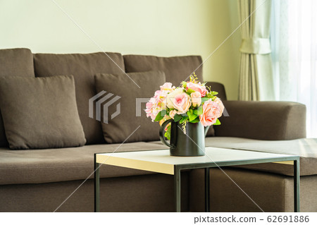Vase flower on table with pillow and sofa decoration interior Vase flower on table with pillow and sofa decoration interior 62691886