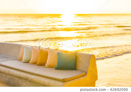 Comfortable pillow on sofa chair around outdoor patio with sea ocean beach view Comfortable pillow on sofa chair around outdoor patio with sea ocean beach view 62692098