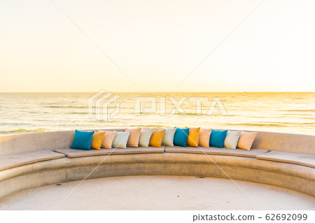 Comfortable pillow on sofa chair around outdoor patio with sea ocean beach view Comfortable pillow on sofa chair around outdoor patio with sea ocean beach view 62692099