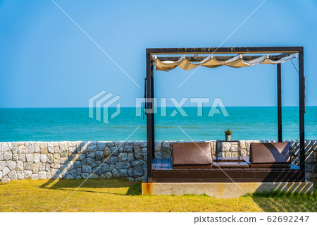Pillow on sofa bed with lounge around beach ocean sea and blue sky Pillow on sofa bed with lounge around beach ocean sea and blue sky 62692247