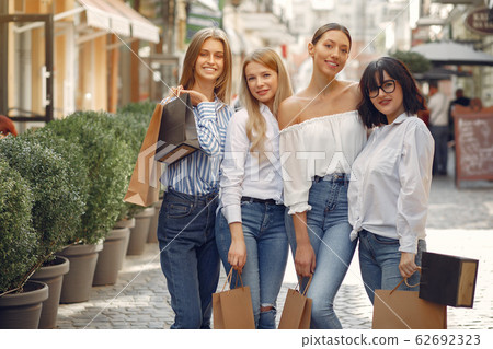 Cute girls with shopping bag in a city Cute girls with shopping bag in a city 62692323