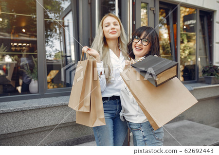 Cute girls with shopping bag in a city 62692443