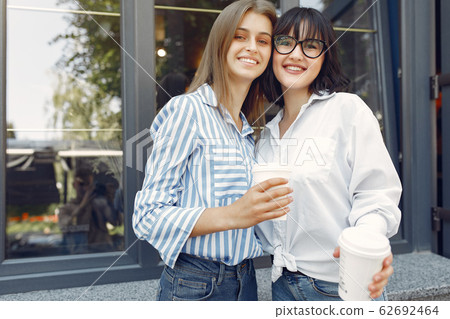 Fashion girls standing in a summer city 62692464