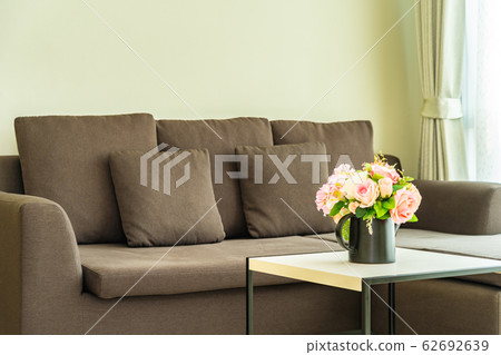Vase flower on table with pillow and sofa decoration interior 62692639