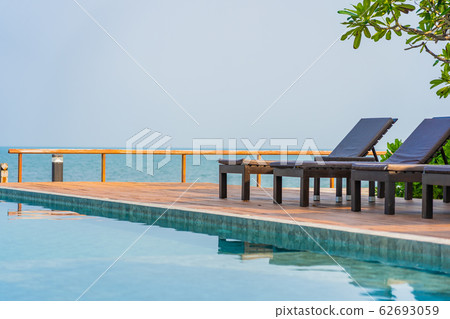 Beautiful empty chair umbrella around outdoor swimming pool in hotel resort for travel Beautiful empty chair umbrella around outdoor swimming pool in hotel resort for travel 62693059