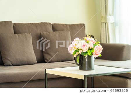 Vase flower on table with pillow and sofa decoration interior 62693336