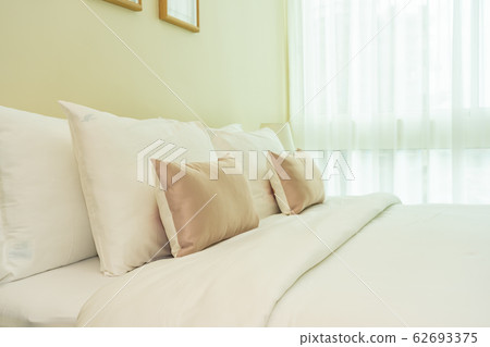 White comfortable pillow on bed decoration interior 62693375