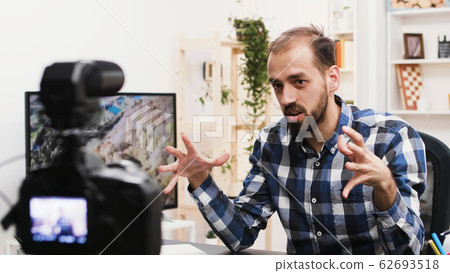 Young man recording a vlog for his social media channel Young man recording a vlog for his social media channel 62693518