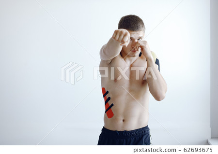 Doctor glues a tepee to an athlete at the hospital 62693675
