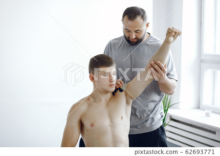 Doctor glues a tepee to an athlete at the hospital 62693771