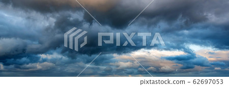 Dramatic panoramic skyscape with dark stormy clouds Dramatic panoramic skyscape with dark stormy clouds 62697053