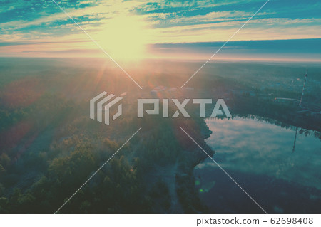 Magical sunset over the countryside. River on the meadow. Rural landscape in the evening. Aerial view 62698408