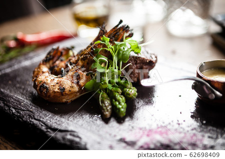 Tasting menu. Beef steak and grilled tiger prawns. Tasting menu. Beef steak and grilled tiger prawns. 62698409