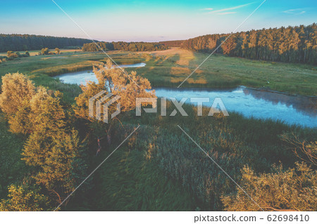 The brook flows through the field. Aerial view The brook flows through the field. Aerial view 62698410