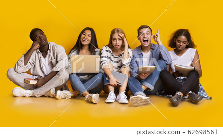 Group of exhausted students studying for school exams Group of exhausted students studying for school exams 62698561