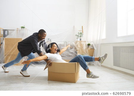 Start repair in apartment. Husband rolling wife in box Start repair in apartment. Husband rolling wife in box 62698579