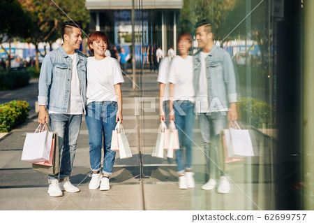 Couple looking at shop windows Couple looking at shop windows 62699757
