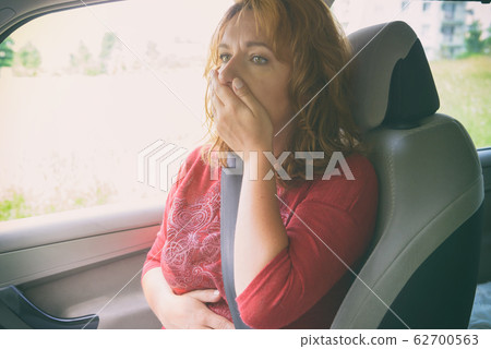 Woman suffering from motion sickness Woman suffering from motion sickness 62700563