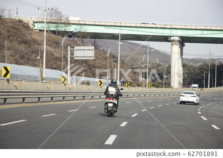 A person riding a motorcycle A person riding a motorcycle 62701891