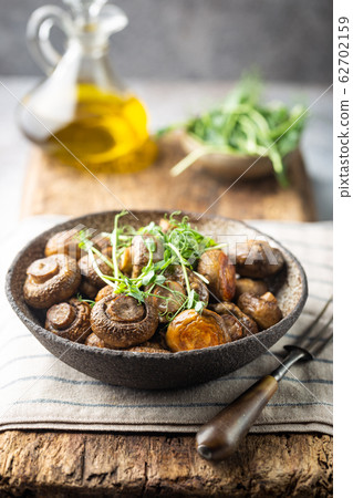 Baked champignons mushrooms Baked champignons mushrooms 62702159