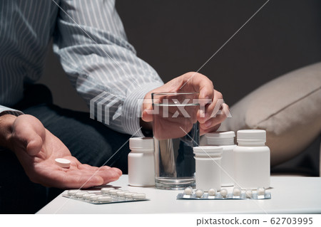 Overworked businessman sitting on the sofa and Overworked businessman sitting on the sofa and 62703995