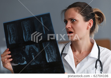 Therapist considering x-ray Therapist considering x-ray 62704106