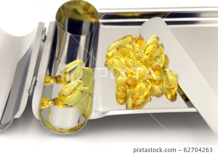 Pill counting tray wth yellow soft gelatin 62704263