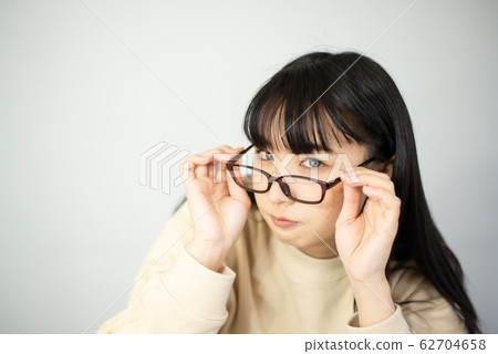 A young woman looking at you with your glasses off A young woman looking at you with your glasses off 62704658