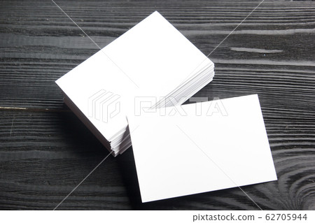 Business card blank on wooden background. Corporate Stationery, Branding Mock-up. Creative designer desk. Flat lay. Copy space for text 62705944