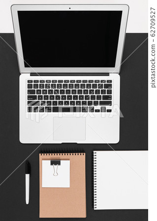 Desktop with laptop, note, pen isolated on black and white background Desktop with laptop, note, pen isolated on black and white background 62709527