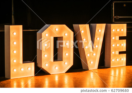 Design of the letters "love" glowing light bulb letters Design of the letters "love" glowing light bulb letters 62709680