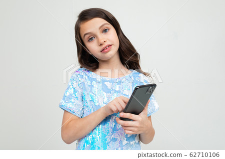 girl with a smartphone in her hands girl with a smartphone in her hands 62710106