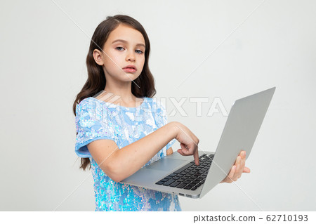 charming girl made an order for an educational course via the Internet using a laptop on a white charming girl made an order for an educational course via the Internet using a laptop on a white 62710193