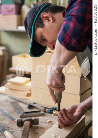 Carpenter working with a chisel Carpenter working with a chisel 62710629