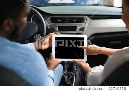 Couple Using Tablet With Empty Screen Sitting In Car, Back-View 62710858