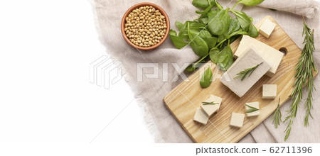 Organic products. Tofu from soybeans on linen tablecloth Organic products. Tofu from soybeans on linen tablecloth 62711396