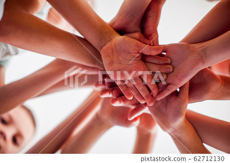 Happy friends putting their hands together, view from down. 62712130