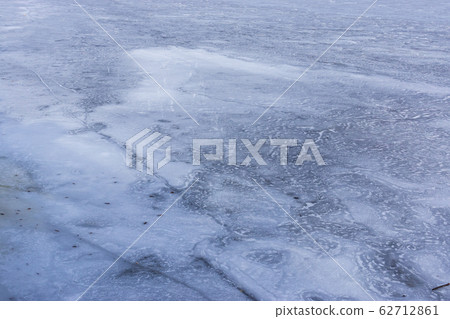Ice background on lake surface in frosty weather in winter Ice background on lake surface in frosty weather in winter 62712861