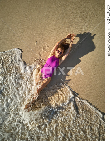 Woman on beach at Seychelles aerial top view 62713927