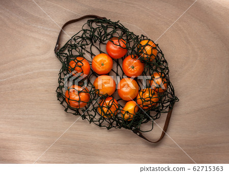 mandarins in green net bag zero waste concept 62715363