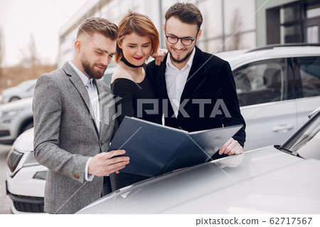 Stylish and elegant couple in a car salon Stylish and elegant couple in a car salon 62717567