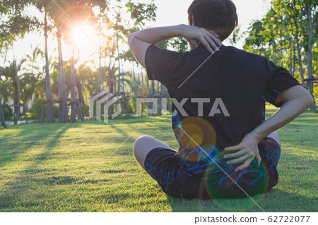 male athlete suffering from neck and back pain and injury at the park. Sport and healthcare concept. 62722077