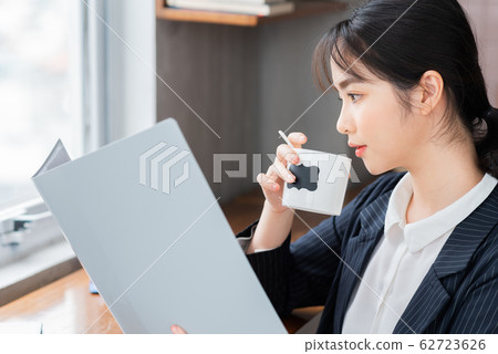A business woman reading the document in the office A business woman reading the document in the office 62723626